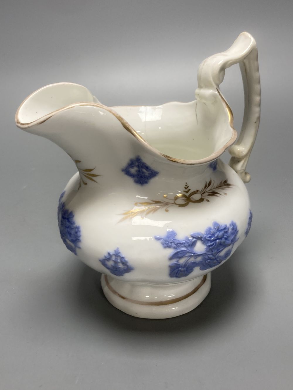Four early 19th century Staffordshire jugs, each with lilac coloured floral applied panels, one dated 1826, tallest 22cm